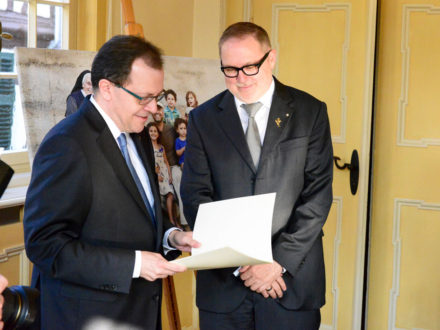 Staatssekretär Thomas Metz übergibt das Bundesverdienstkreuz an den Strahlemann-Stiftungsgründer Franz-Josef Fischer